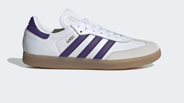 Side view of Lionel Messi's white and purple adidas Samba sneakers.
